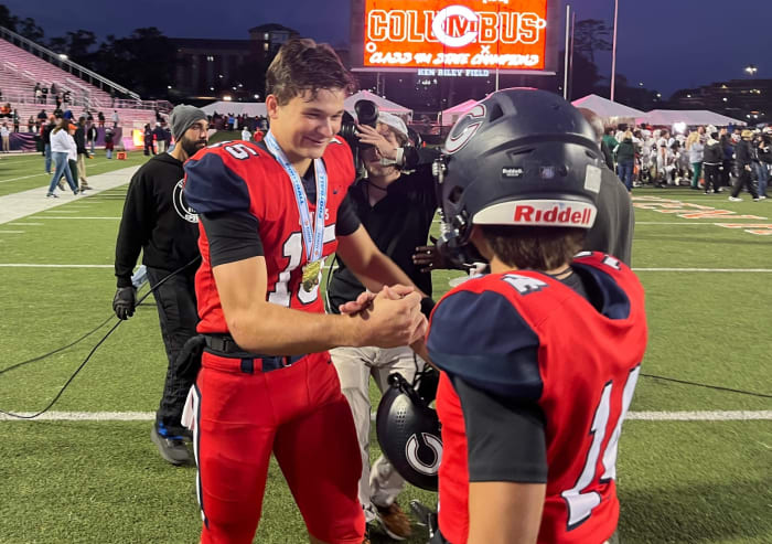 Columbus senior quarterback Alberto Mendoza celebrates the Explorers Class 4M championship with wide receiver Javi Mirabal on Friday at Bragg Memorial Stadium in Tallahassee. Mendoza is a member of Indiana's 2024 recruiting class.